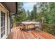 Relax on the wood deck with a hot tub and forest view at 10142 S Turkey Creek Rd, Morrison, CO 80465