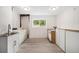 Laundry room with wood-style vinyl floors, a utility sink, washer, dryer and cabinets at 10142 S Turkey Creek Rd, Morrison, CO 80465