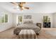Bright bedroom with a decorative ceiling fan and views from multiple windows at 10142 S Turkey Creek Rd, Morrison, CO 80465