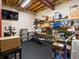 Finished storage and workout space features a TV, weight bench, and shelving units for organization at 30382 Kings Valley East, Conifer, CO 80433