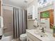 Bright bathroom with vanity, tub, and window providing natural light at 30382 Kings Valley East, Conifer, CO 80433