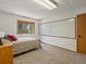 This carpeted bedroom offers a large window with forest views and a white dry erase board at 30382 Kings Valley East, Conifer, CO 80433
