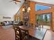 Dining room with wood floors, a fireplace, and views of the outdoor scenery at 30382 Kings Valley East, Conifer, CO 80433