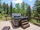 The hot tub on the back porch offers views of the forest and a tranquil place to unwind at 30382 Kings Valley East, Conifer, CO 80433