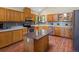 Traditional kitchen with wood cabinets, a gray backsplash, and an island countertop at 30382 Kings Valley East, Conifer, CO 80433