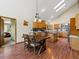 Kitchen area featuring a dining table, kitchen island, and hardwood floors at 30382 Kings Valley East, Conifer, CO 80433