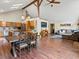 Open floor plan featuring a kitchen, dining area, and living room with wood accents at 30382 Kings Valley East, Conifer, CO 80433