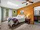 Charming main bedroom with wood panel accent wall, plush carpet, and ensuite bathroom at 30382 Kings Valley East, Conifer, CO 80433