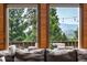 Living room with an outdoor patio view of trees and mountains in the distance at 30382 Kings Valley East, Conifer, CO 80433