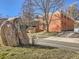 Brick apartment building with manicured lawn and rock sign on a clear, sunny day in a quiet neighborhood at 625 Pearl St # 23, Boulder, CO 80302