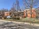 Brick building featuring mature trees and outdoor parking at 625 Pearl St # 23, Boulder, CO 80302