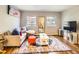 Bright and airy living room featuring a cozy couch, colorful rug, and ample natural light at 625 Pearl St # 23, Boulder, CO 80302