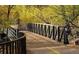 Nature path crossing wooden bridge among changing autumn foliage at 625 Pearl St # 23, Boulder, CO 80302