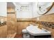 Basement bathroom with tan tile and a gold faucet at 150 Harrison St, Denver, CO 80206