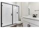 Modern bathroom featuring shower with glass door, and vanity with countertop sink at 4728 Twelve Oaks Way, Castle Rock, CO 80104