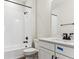 Modern bathroom with white tiled shower, dark accents, and a sleek vanity at 4728 Twelve Oaks Way, Castle Rock, CO 80104