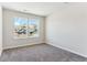 Well lit bedroom featuring wall to wall carpet and a view of the houses nearby through the window at 4728 Twelve Oaks Way, Castle Rock, CO 80104