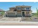 Beautiful two-story home with a three car garage, stone accents, and a welcoming front porch at 4728 Twelve Oaks Way, Castle Rock, CO 80104