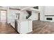 Modern kitchen with island and stainless appliances; seamless flow into the adjacent living area at 4728 Twelve Oaks Way, Castle Rock, CO 80104