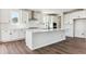 Stylish kitchen featuring a large center island, white cabinets, stainless appliances, and subway tile at 4728 Twelve Oaks Way, Castle Rock, CO 80104