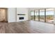 Spacious living room with a fireplace, large windows, and seamless access to the deck at 4728 Twelve Oaks Way, Castle Rock, CO 80104