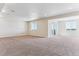 Spacious living room featuring carpet and large windows with a view of the yard at 4728 Twelve Oaks Way, Castle Rock, CO 80104