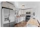 Bright kitchen features modern appliances, white cabinets, and an elegant chandelier at 1526 S Elm St, Denver, CO 80222