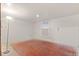 An open and unfinished basement featuring wood floors, neutral paint, and a small window at 1561 Newton St, Denver, CO 80204