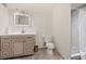 Bathroom featuring a shower-tub combo, a vanity, a toilet, and neutral paint at 1561 Newton St, Denver, CO 80204