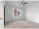 Bright bedroom featuring carpet flooring, a ceiling fan, and a window at 1561 Newton St, Denver, CO 80204