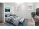Bedroom with a bed, carpeted floors, two windows, and neutral paint at 1561 Newton St, Denver, CO 80204