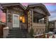 Charming brick home with a covered porch and well-maintained front yard at 1561 Newton St, Denver, CO 80204