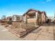 Charming home with a front porch, patterned brickwork, and a well-manicured front yard at 1561 Newton St, Denver, CO 80204