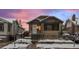 Charming bungalow with brick and siding, snowy front yard, and inviting curb appeal at 1561 Newton St, Denver, CO 80204