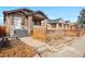 Inviting front yard with landscaped garden beds, walkway, and steps leading to the porch at 1561 Newton St, Denver, CO 80204