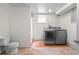 A simple laundry room with a side-by-side washer and dryer and neutral paint at 1561 Newton St, Denver, CO 80204