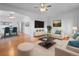 Bright living room with hardwood floors, ceiling fan, stylish furniture, and a seamless flow to the dining area at 1561 Newton St, Denver, CO 80204