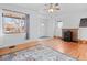 Bright living room features hardwood floors, fireplace, ceiling fan, and a large window at 1561 Newton St, Denver, CO 80204