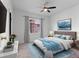 Inviting bedroom with hardwood floors, a ceiling fan, and stylish decor at 1561 Newton St, Denver, CO 80204