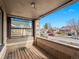 A charming covered front porch with wood flooring and views of the neighborhood at 1561 Newton St, Denver, CO 80204