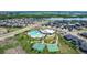 Amazing aerial view of community amenities including a pool, tennis courts, and green spaces at 12513 Shore Point St, Firestone, CO 80504