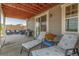 Comfortable covered back porch featuring chaise lounges and an outdoor grill at 12513 Shore Point St, Firestone, CO 80504