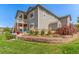 Well-maintained backyard featuring a terraced garden, shed, and upper-level porch at 12513 Shore Point St, Firestone, CO 80504