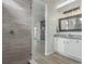 Beautiful bathroom features a glass-enclosed shower, granite countertops, and modern vanity lighting at 12513 Shore Point St, Firestone, CO 80504