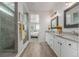 Elegant bathroom features a walk-in shower, double vanity with granite countertops, and modern fixtures at 12513 Shore Point St, Firestone, CO 80504