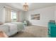 Cozy bedroom showcasing ample space with an accent chair and coastal-inspired decor at 12513 Shore Point St, Firestone, CO 80504