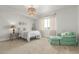 Bright bedroom with a sitting area, complemented by a woven pendant light at 12513 Shore Point St, Firestone, CO 80504