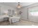 Comfortable bedroom featuring neutral tones, soft carpet, and natural light from the window at 12513 Shore Point St, Firestone, CO 80504