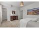 Serene bedroom showcases a rustic wood media cabinet and a walk-in closet at 12513 Shore Point St, Firestone, CO 80504