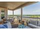 Covered deck with outdoor seating and a scenic lake view at 12513 Shore Point St, Firestone, CO 80504